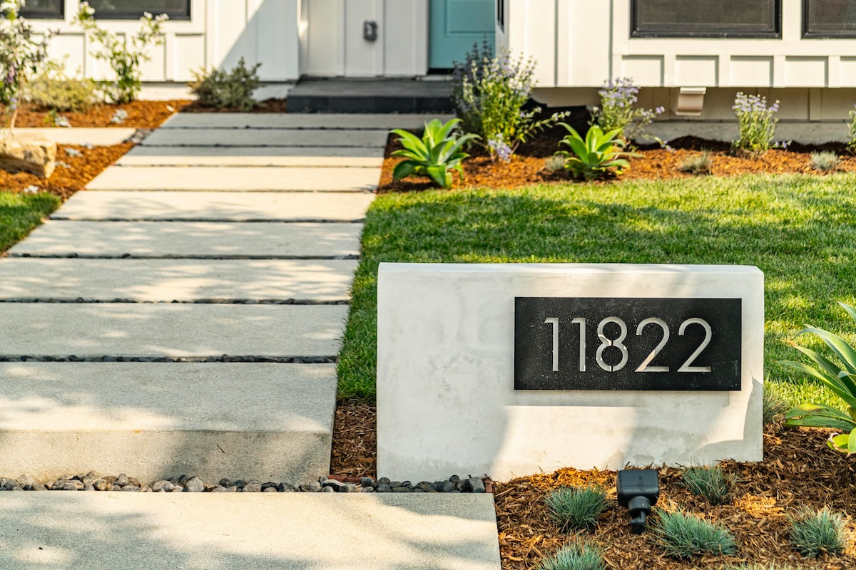 Bold MFG Pemberton House Numbers on display on stone block in front of house